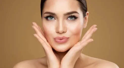 Preenchimento labial lc estetica Beauty Model showing Cheekbones and Full Lips. Beautiful Woman Face Skin Care. Women Dermal Filler and Permanent Make up Cosmetology. Lip Augmentation Facial Lifting Spa Massage over Beige Background